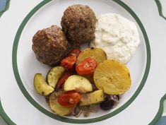 a white plate topped with meatballs and veggies