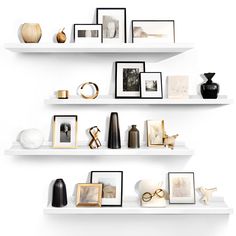 three white shelves with pictures, frames and vases on them in the same room