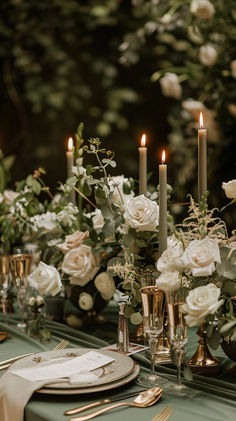 the table is set with candles, flowers and napkins for an elegant wedding reception