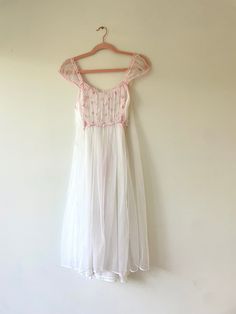 A beautiful and very special mid century style nightgown dress that has been in my family since the late 1950's or early 1960's. A pretty and timeless style that can be worn as lingerie, and also makes the prettiest dress for day or night, for party or brunch, for wedding guest. Perfect for a  bride to be for her bridal trousseau.   Brand: Unknown No Label Condition:  Excellent - No Visible Stains Or Flaws.  Like New Circa:  Late 1950's / Early 60's Size:  XS-Small Color: White/ Pink Layered She Cottagecore Bedtime Dresses For Summer, Cottagecore Summer Bedtime Dresses, Vintage Sheer Nightgown For Summer, Spring Cottagecore Home Dresses, Vintage Lace Trim Dresses For Loungewear, Vintage Sheer Sleepwear, Retro Bedtime Dresses For Summer, Vintage Spring Sleepwear For Home, Vintage Spring Sleepwear