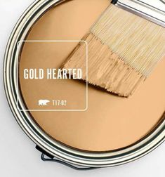 a close up of a paint can with a brush in it and the words gold hearted