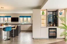 a modern kitchen with stainless steel appliances and bar stools