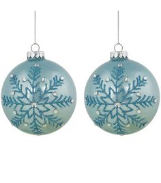 two blue christmas balls with snowflakes hanging from the top and one is decorated with silver beads