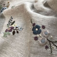 an embroidered fabric with flowers on it