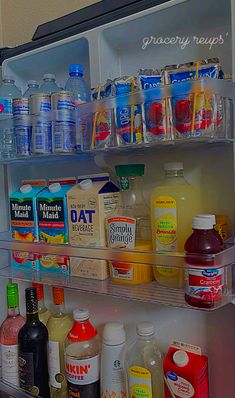 an open refrigerator filled with lots of different types of drinks and condiments on shelves