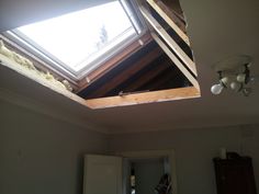 a room with a skylight that is missing the roof and has been torn off