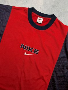 This Nike tee is a true gem for every fan of retro fashion. The vintage 90s Nike Central Logo Swoosh T-shirt in XL size features a bold red color with the iconic Nike logo as the accent. It is a classic regular fit t-shirt perfect for any casual occasion. The shirt is designed for men and belongs to the T-Shirts category under Men's Clothing. It is also categorized under Shirts and Clothing, Shoes & Accessories. The tee has a USA, 80s, and 90s theme and would be a great addition to any retro-ins Nike In The 90s, Vintage Nike T Shirt, 90s Style Red T-shirt For Sports, Retro Sports Tops With Graphic Design, 90s Style Red T-shirt, Red Retro Sports T-shirt, Red 90s Style Sports T-shirt, 90s Red T-shirt For Sports, Vintage Red T-shirt For Sports