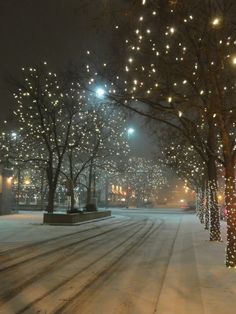 a snowy street with lots of lights on it