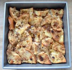 a square pan filled with food on top of a wooden table