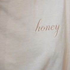 the word honey is embroidered on a white shirt