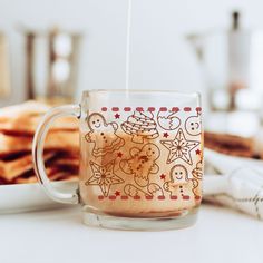 a glass mug filled with liquid sitting on top of a table next to crackers