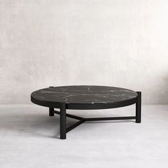 a black coffee table sitting on top of a white floor