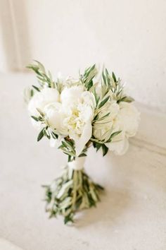 a bouquet of white flowers sitting on top of a table