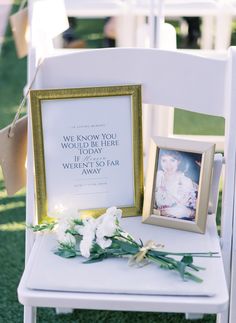 a white chair with a framed photo and flowers on it, next to a sign that says we know what we are here today