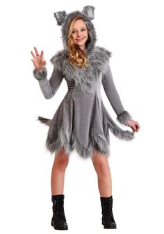 a woman dressed in a wolf costume posing for the camera with her hands up and smiling