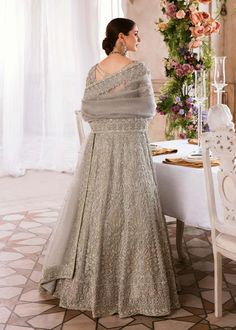 Designer Red Lehenga Choli for Pakistani Wedding Dresses comes in a magic of linear design with appealing embellishments on a grey hue is what makes “Ismat” a stunning outfit. The timeless silhouette is crafted on pure organza, with floral and linear motifs. Grey Choli: It is the color of confidence on your big day. The blouse in the rose grey shade is embellished with intricate designs, silverwork, and fine details. The V shape neckline and full sleeves look excellent with the lehenga. Beautifu