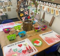 a wooden table topped with lots of crafting supplies next to paper plates and bowls