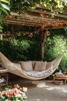 a hammock hanging from a pergolated area with lights strung over it