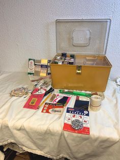 an open suitcase sitting on top of a table covered in various types of cards and other items