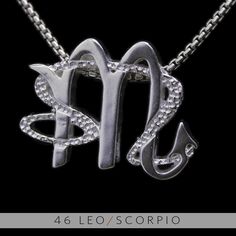 a silver necklace with the letter m on it's front and back ends in two letters