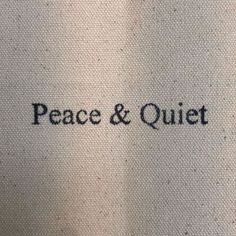 the words peace and quiet are written in black ink on a white background with brown trim