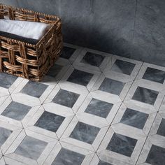 a basket sitting on top of a tiled floor