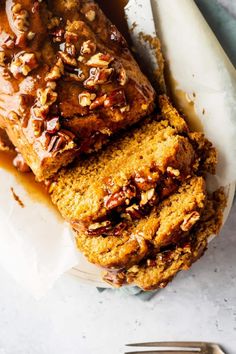 slices of banana nut bread on a plate with a knife and fork next to it