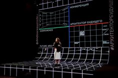 a woman standing on top of a stage in front of a screen with different lines