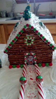 a gingerbread house made to look like it has candy canes