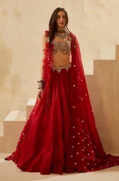 Editor's Note Look uber glamorous and make heads turn with this gorgeous red lehenga set. This blouse with our signature Ambi jaal embroidery doused in pearls and sequins with silver-gold accen... Bhumika Sharma, Jaal Embroidery, Organza Lehenga, Organza Skirt, Red Lehenga, Embroidered Wedding, Organza Dupatta, Embroidered Neckline, Indian Fashion Designers