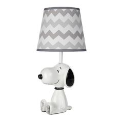 a lamp with a snoopy dog on the base and a chevron fabric shade