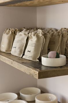 several bags and bowls on a shelf in a room