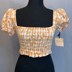 Smak Parlour Peach Gingham Floral Smocked Crop Top. Size Xs. New With Tag. No Holes, Stains Or Flaws. If You Need Exact Measurements Please Leave Me A Comment Below! Bundle Any 3 Or More Items For 15% Off Automatically. Make A Bundle Or Leave Me An Offer. I’m Very Flexible And Willing To Negotiate! I Just Need This Stuff Gone! **Please Note** I Do Not Ship Out On Weekends. This Is My Business And I Operate During Business Hours. Place Orders By Noon (Central Time) On Fridays If You Want It To Be Spring Gingham Top With Square Neck, Gingham Square Neck Top For Spring, Spring Gingham Square Neck Top, Chic Gingham Smocked Top For Summer, Casual Fitted Smocked Top With Square Neck, Casual Gingham Top With Square Neck, Casual Gingham Square Neck Top, Cute Fitted Top With Smocked Back, Cute Fitted Tops With Smocked Back