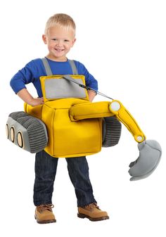 a young boy in a construction worker costume holding a toy excavator and shovel