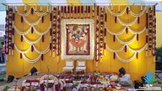 a decorated stage set up with food and decorations on the ground in front of it