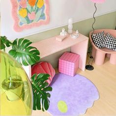 a living room filled with furniture next to a pink table and potted palm tree