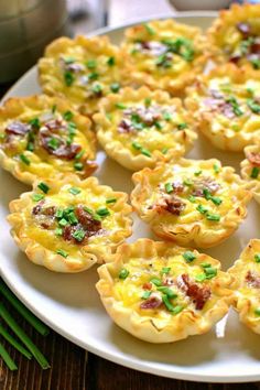 small quiche cups are arranged on a white plate