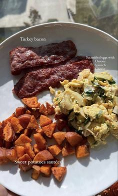 a white plate topped with bacon, eggs and sweet potatoes