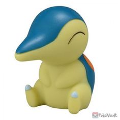 a yellow and blue toy sitting on top of a white surface with its eyes closed