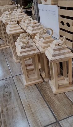 several wooden lanterns are lined up on the floor