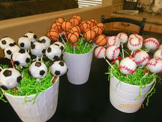 several vases filled with fake soccer balls and grass