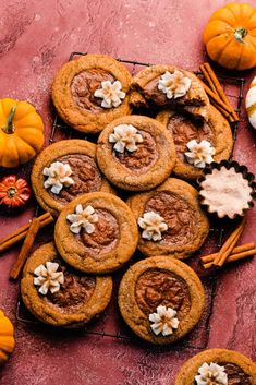 pumpkin spice cookies on a cooling rack with cinnamon sticks and other treats around them,