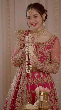 a woman in a red and gold wedding dress