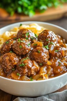 a white bowl filled with meatballs and pasta