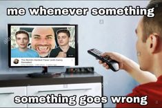 a man holding a remote control in front of a tv screen with the caption, me whenever something something goes wrong