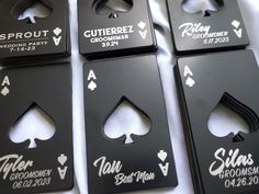 four black bottle openers with white lettering on them