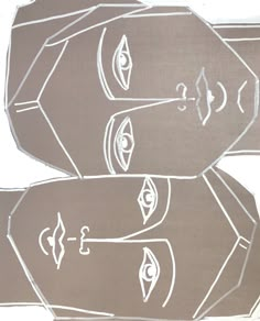 two brown and white paper cut outs with faces on them