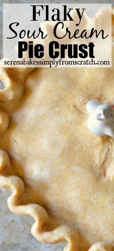 a pie crust in a pie pan with a piece missing from it and text overlay that reads flaky sour cream pie crust