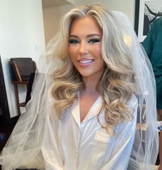 a woman with blonde hair wearing a wedding veil