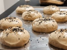 freshly baked buns with sprinkles on a baking sheet